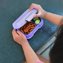 Purple kids lunch box with lid open, containing pretzels, cucumber, and pasta