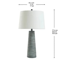 Table lamp with white fabric shade and ribbed light gray ceramic base, front view