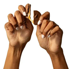 Hands holding caramel and chocolate cups with gooey filling