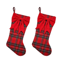 Two red plaid Christmas stockings with bows and hanging loops