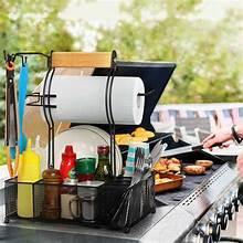 Barbecue serving caddy with roll holder, utensil slots, and condiment bottles on table