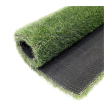 Artificial grass roll end with green fibers and dark backing