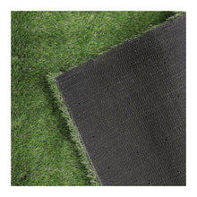 Artificial grass edge showing green turf and dark woven backing