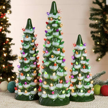 Three green ceramic tabletop Christmas trees with multicolor lights, tall center tree
