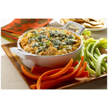 Creamy mayonnaise sauce in white bowl with sliced vegetables for dipping