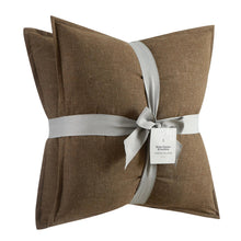 Brown linen square throw pillow set with ribbon bow at center seam