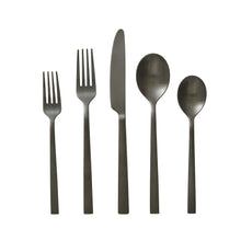 Black stainless steel flatware set with multiple utensils arranged