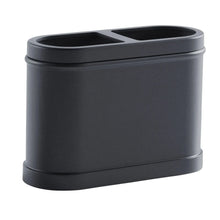 Black metal toothbrush holder with two open slots for toothbrush heads