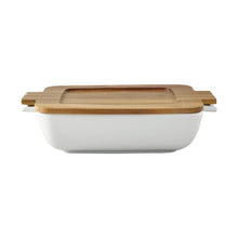 White ceramic oven-to-table serving dish with acacia lid and wood base