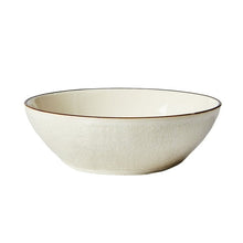 Cream stoneware dinner bowl with speckled texture and dark rim