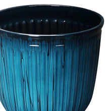 Light blue ribbed resin planter with dark inner rim, open top, close-up side view