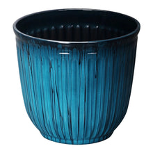 Light blue recycled resin planter with vertical ribbed texture and dark rim, round shape