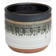 Round ceramic plant planter, dark top over white body with speckled drip glaze