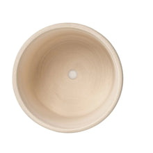 Round white ceramic planter top view with drainage hole