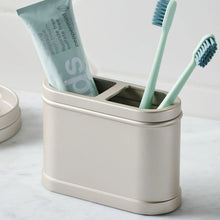 Satin nickel metal toothbrush holder with two slots holding two toothbrushes