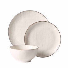 Cream stoneware dinnerware set with matching bowl and round dinner plates, textured glaze