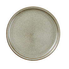 Cream ceramic dinner plate with speckled glaze and raised tan outer rim