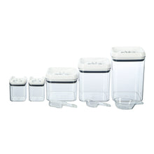 Stack of clear plastic baking storage containers with flip-top lids and blue seal trim