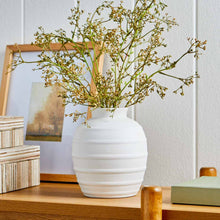 White textured ribbed ceramic vase with wide round body and short neck