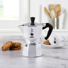 Bialetti Moka stovetop espresso maker with black handle and spout, stainless finish and base knob