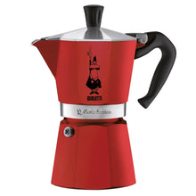 Red Bialetti moka stovetop espresso maker with black handle and funnel top