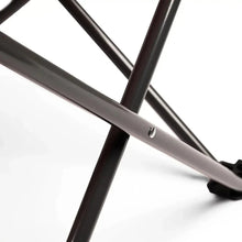 Black folding camping chair frame leg and cross brace close-up