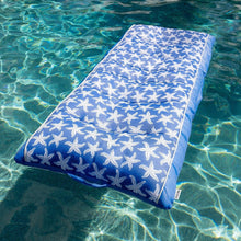 Blue and white starfish inflatable pool float, rectangular raft floating in water