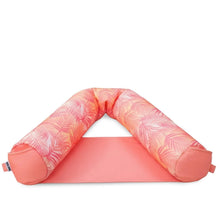 Pink palm-pattern sling pool float with padded head ring and front arm cushions