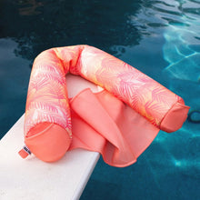Pink palm sling pool float with open center seat and padded side arm sections