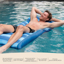 Blue striped pool float with raised edges, used on clear swimming pool water