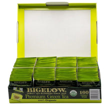 Opened tea bag carton displaying stacked individually wrapped green tea bags
