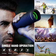 Black monocular held near face with green lens, single-hand viewing