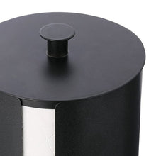 Close-up of matte black metal toilet paper holder lid and dispensing slot