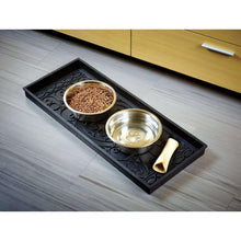 Black rubber boot tray with embossed swirls, holding two bowls and a utensil