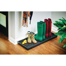 Black rubber boot tray mat with ornate embossed design, holding boots