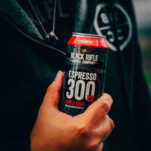 Hand holding Espresso 300 coffee can, Rich Mocha, Black Rifle Coffee Company