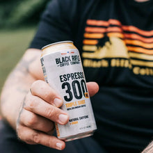 Espresso 300 caramel vanilla coffee can held in hand