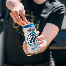 Black Rifle Espresso 300 vanilla bomb can in hand, front label facing up