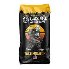 Ground coffee bag, black with gold top; Black Rifle Coffee Company logo and Tactisquatch graphic.