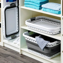 Collapsible laundry basket on shelf with perforated edges, holds folded towels