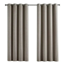Pair of gray blackout window curtains with metal grommets on a rod