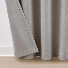 Gray blackout curtain panel hem resting on the floor