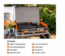 Propane camping griddle with lid, side burner, control knobs, and protective cover