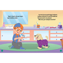 Hardcover storybook open page with Blippi holding a toy beside a small dog