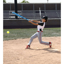 Plastic baseball bat with two green balls, held by a child in batting pose