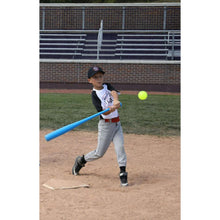 Plastic baseball bat with green ball, child holding bat near home plate