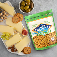 Whole natural raw almonds resealable bag with sliced cheese and crackers on a platter.