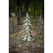 Metal cedar tree garden accent with layered branches, teal-blue and gray, outdoors