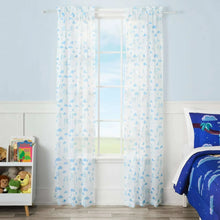 Kids sheer drape panel, white with light blue character print, hanging on window