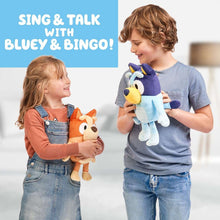 Talking Bingo plush in child's hands, orange and cream dog character with large ears